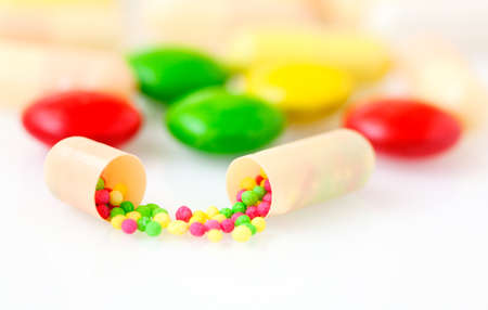 Macro view of medicine capsular opened, contains color granular drug 