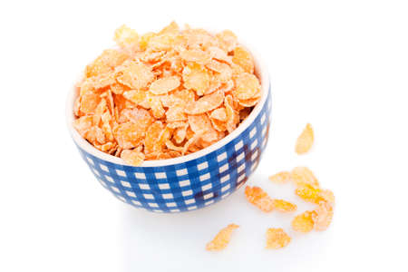 Cornflakes in a blue porcelain bowl, isolated on white background 