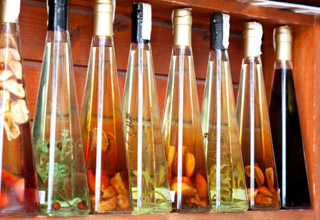 colorful liqueur and vinegar bottles on a market in croatia.の写真素材