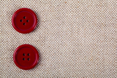 red buttons on the old clothesの写真素材