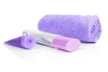 cosmetic bottles, with rolled towel, isolated on whiteの写真素材