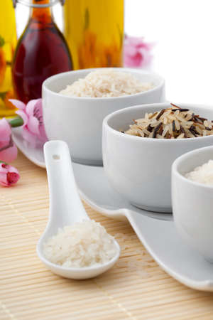 uncooked rice in porcelain spoonの写真素材
