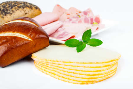 Cheese slices, sausage and bun  for breakfast, isolated on white background