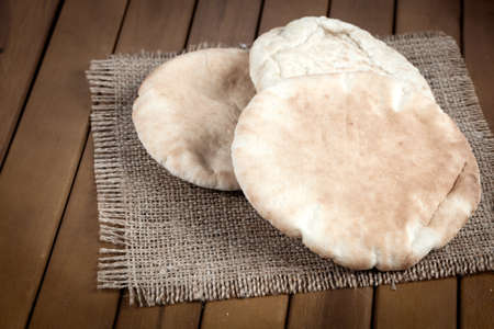 pitta bread (Lebanese Bread), over old burlap backgroundの写真素材