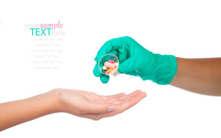 doctor hands giving capsule and pill, on white backgroundの写真素材