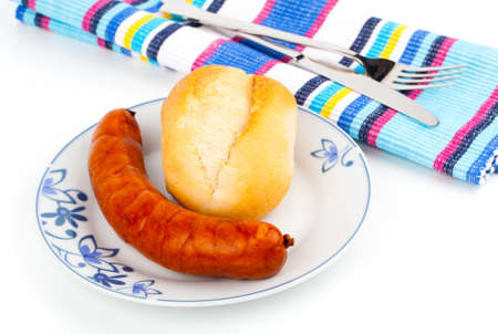 Stack of cooked sausages on a plate with bunの写真素材