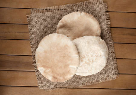 pitta bread  Lebanese Bread , over old burlap backgroundの写真素材