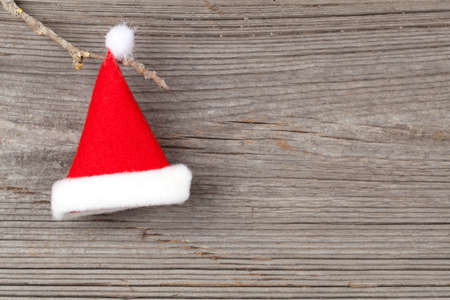 Single Santa Claus red hat on wooden backgroundの写真素材