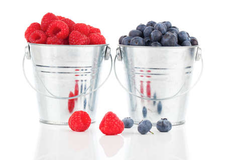blueberry and raspberries berries in a metal bucketの写真素材