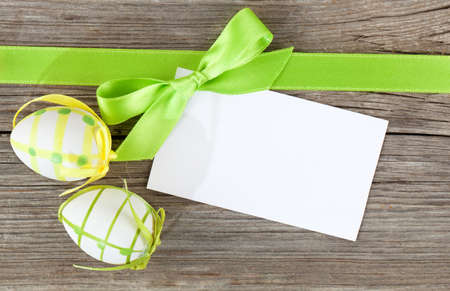 easter eggs and blank for text, on wooden backgroundの写真素材