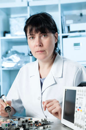 Girl debugging an electronic precision deviceの写真素材