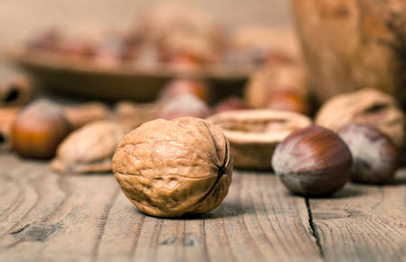 macro shot of walnuts on a wooden table.