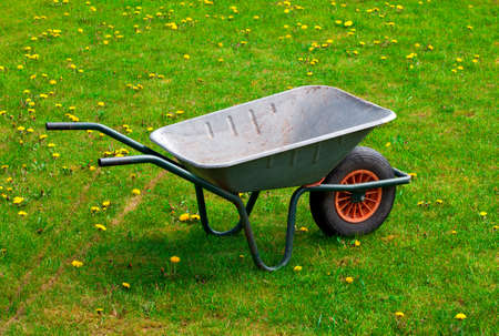 garden-wheelbarrow on green grassの写真素材