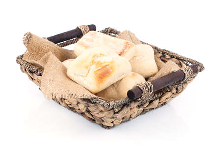 fresh baked buns in a basket on white backgroundの写真素材