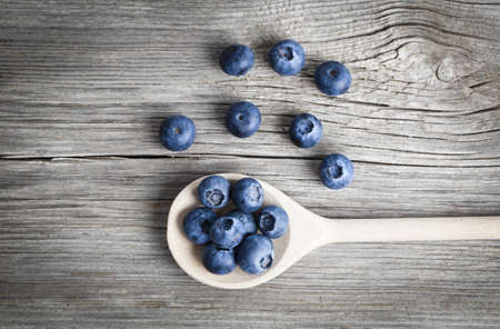 Blueberries on a wooden spoonの写真素材