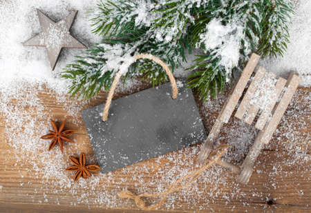 Christmas decoration over snow, wooden backgroundの写真素材
