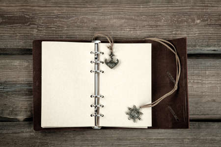 Vintage book, open, on old wooden table, with clipping pathの写真素材