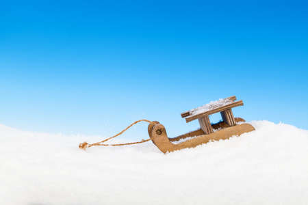 Old vintage wooden sled on blue backgroundの写真素材