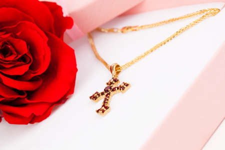 Golden Cross with garnets in packagedの写真素材