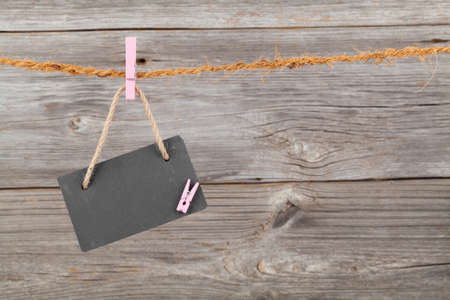 Black board of slate on old rustic wooden background,の写真素材