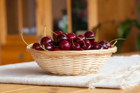 Cherries on wooden table, outdoorの写真素材