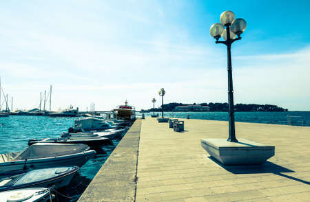 wooden berth with street-lamp on sea background. Pula Croatiaの写真素材