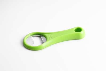 Green bottle opener isolated on white background