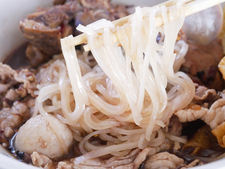 close up to boat noodle blood soup with meat ball, meat pork with spicy taste, asian noddle for...