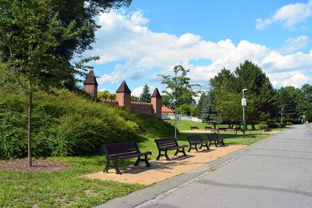 Park near medieval fortification in Nymburk, Central Bohemia, Czech republic. Benches along wayの写真素材