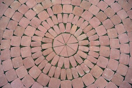 New red pavement of cobble stones in a circle patternの写真素材
