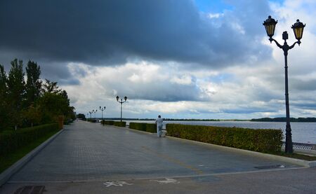 View on the Volga quay of the Samara city in anticipation of thunderstorm. City embankment before rain at cloudy autumn dayの写真素材