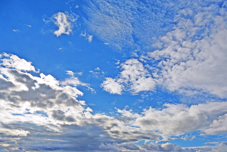 Light Blue sky with white cumulus and cirrus clouds backgroundの写真素材