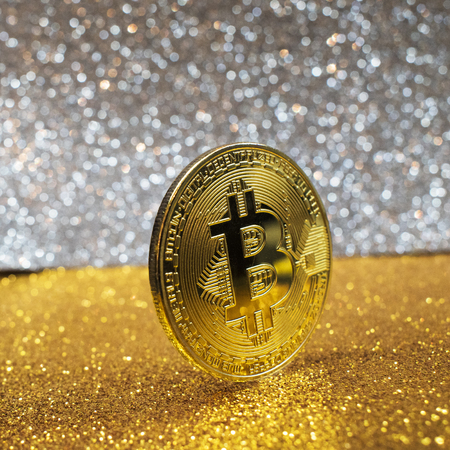 golden bitcoin coin with glitter lights background, crypto currency concept.