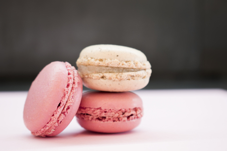 Tender pink and cream macarons on black stone background. soft focusの写真素材
