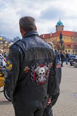 man with embroidery on a leather motorbike jacket, Podebrady castle on backのeditorial素材