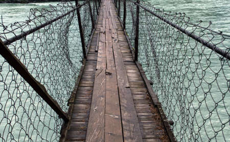 old wooden bridge with netting across  Katun in Altaiの写真素材