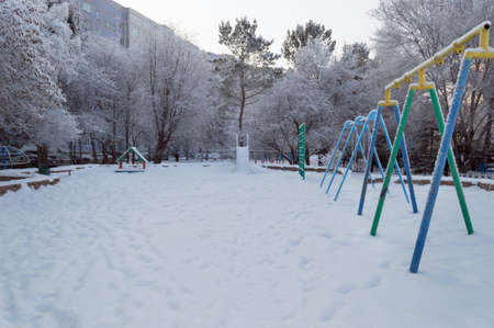 kids playground with trees covered with snowの写真素材