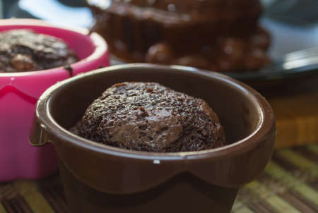 freshly baked chocolate muffin in silicone mold with blurred backgroundの写真素材