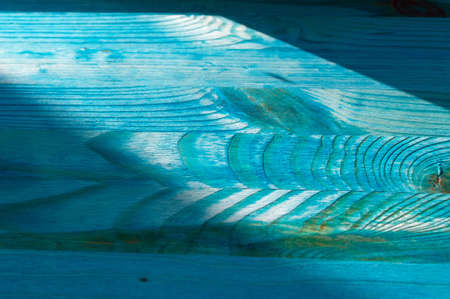 blue wooden background under sunlight with shadowsの写真素材