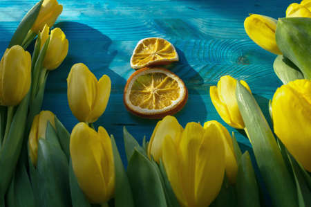 concept of 8th of march day with yellow tulips and 8 made of orange slicesの写真素材