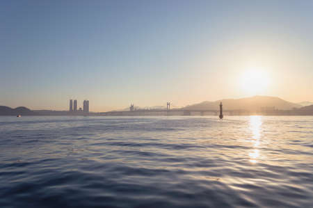 view on Gwangandaegyo Bridge at sunset from the sea Busan, South Koreaの写真素材