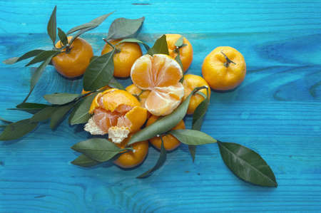 view from above on pile of mandarines on blue backgroundの写真素材