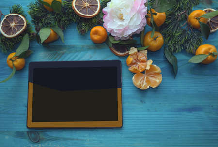 colorful tablet with winter holidays frame above it and space for text