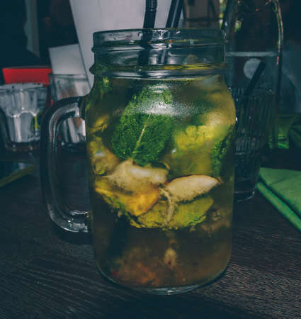 Close up view of iced fruity drink in mason jar on tableの写真素材