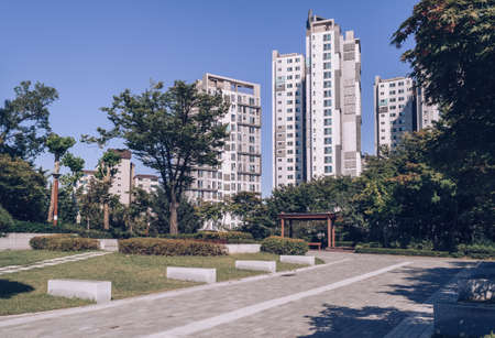 Small park in front of residential apartments in Seoul on sunny September day