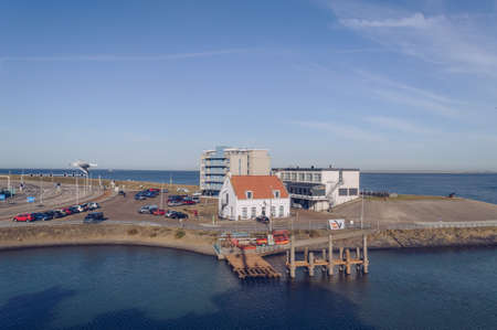Den Helder, The Netherlands, October 13, 2018: view from ferry on Hotel "Lands End" and Pepper house with parking lot and coastlineのeditorial素材