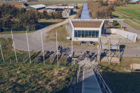 Texel, The Netherlands, October 13, 2018: tourists parking their bycicles near observation deck with sea view on Texel islandのeditorial素材