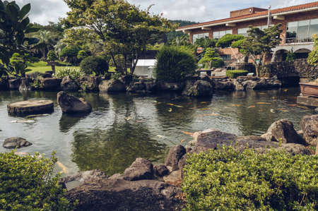 Jeju Island, South Korea, september 05, 2019: pond with koi carps inside of Spirited gardenの写真素材
