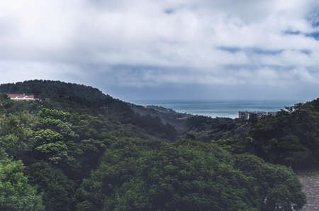 subtropical landscape with sea view afar on cloudy dayの写真素材