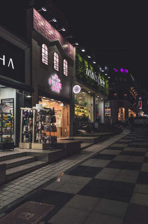 Jeju, South Korea, september 09, 2019: exteriors of shops with glowing signboards at nighttime on shopping streetのeditorial素材